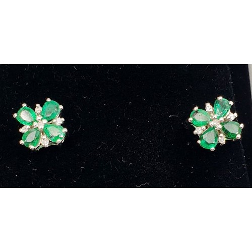 14 - A pair of 9ct white gold earrings set with emeralds and diamonds. UK shipping £14.