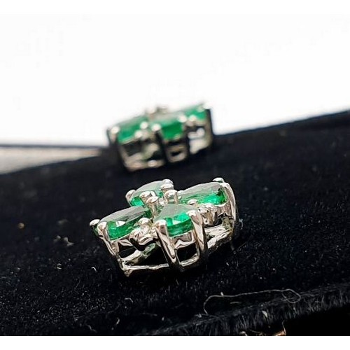 14 - A pair of 9ct white gold earrings set with emeralds and diamonds. UK shipping £14.