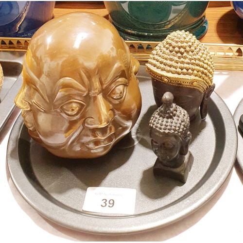 39 - A brass four sided Buddha's head and two resin ones, the tallest, 4.25