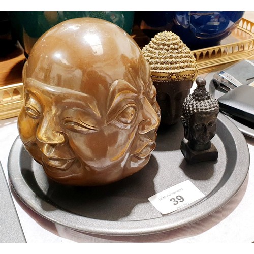 39 - A brass four sided Buddha's head and two resin ones, the tallest, 4.25