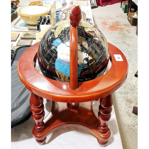 53 - A Gem globe in a wooden stand, height 18