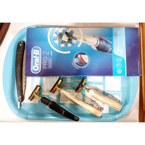 129 - A new in box Oral B Pro 2 electric tooth brush, vintage razors and a cut-throat razor. UK shipping £... 