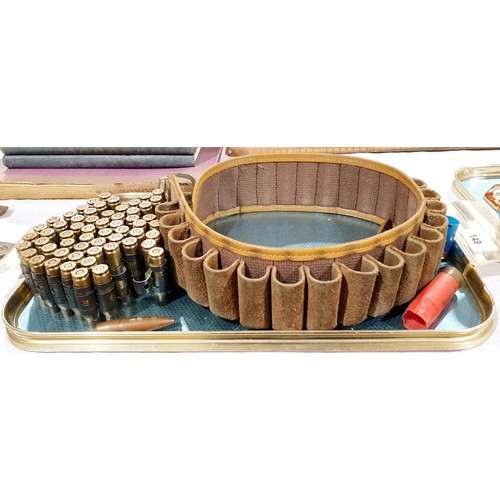 149 - Inert bullet cases and shells and a shotgun cartridge belt. UK shipping £14.