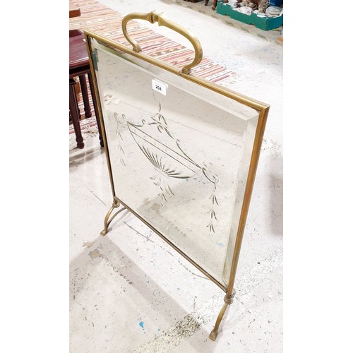 204 - An early 20th century brass fire screen with a cut glass mirror insert, height 29.5