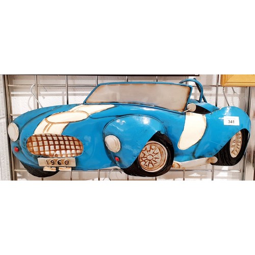 341 - A metal wall sculpture of an AC Cobra, width 24