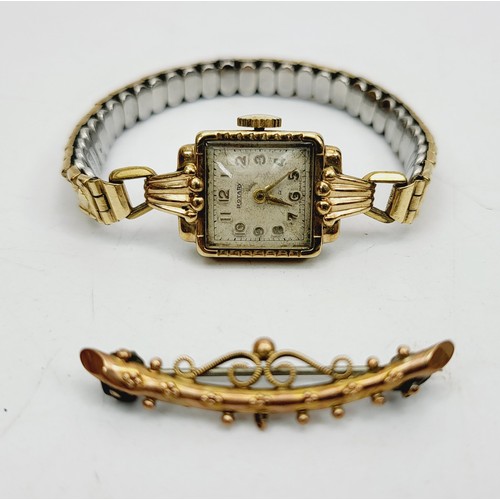 37 - An antique 9ct gold bar brooch, weight 3g together with a lady's 9ct gold cased wrist watch on expan... 