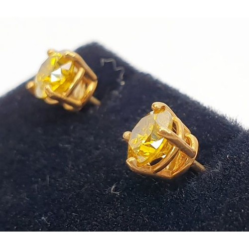 13 - A pair of 9ct gold earrings set with canary yellow diamonds. UK shipping £14.