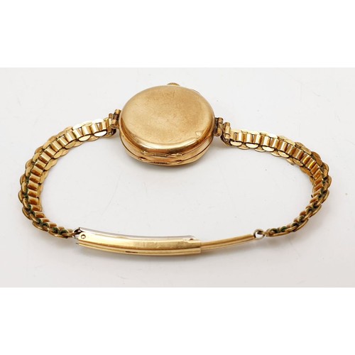 17 - A 9ct gold cased wrist watch, A/F on a rolled gold bracelet. UK shipping £14.