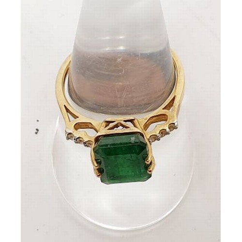 22 - A 9ct gold ring set with an emerald and white stones, gross weight 2.6g, size P. UK shipping £14.