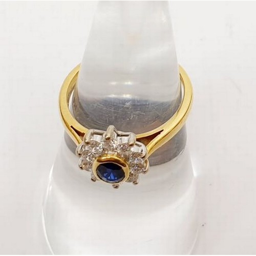 38 - An 18ct gold cluster ring set with diamonds and a sapphire in a rub over setting, gross weight 3.3g,... 