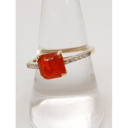 56 - A hallmarked 9ct gold ring set with a fire opal and white stones, gross weight 1.8g, size Q. UK ship... 