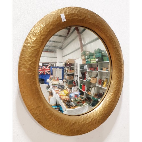 A vintage convex wall mirror with a hammer beaten brass frame, diameter ...