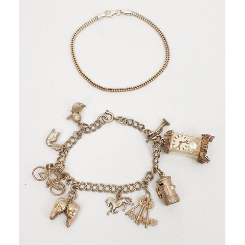 8 - A silver charm bracelet with silver and white metal charms together with a silver bracelet, gross we... 