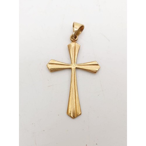 18 - A 9ct gold cross pendant, weight 0.7g. UK shipping £14.