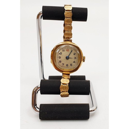 20 - A 9ct gold cased wrist watch, A/F on a rolled gold bracelet. UK shipping £14.