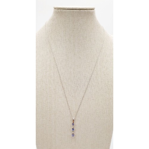 25 - A 9ct white gold pendant set with tanzanite and diamonds on a 10ct white gold chain, weight 1.5g. UK... 