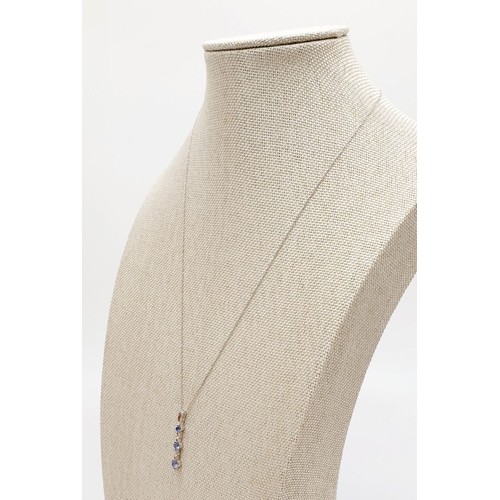 25 - A 9ct white gold pendant set with tanzanite and diamonds on a 10ct white gold chain, weight 1.5g. UK... 