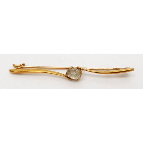 27 - A 15ct gold bar brooch set with a white stone, weight 3.2g. UK shipping £14.