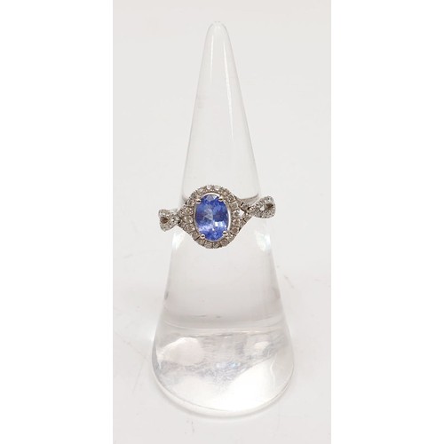 45 - A 14ct white gold ring by Sophia Fiori set with a tanzanite and diamonds, size J/K, weight 2.5g. UK ... 