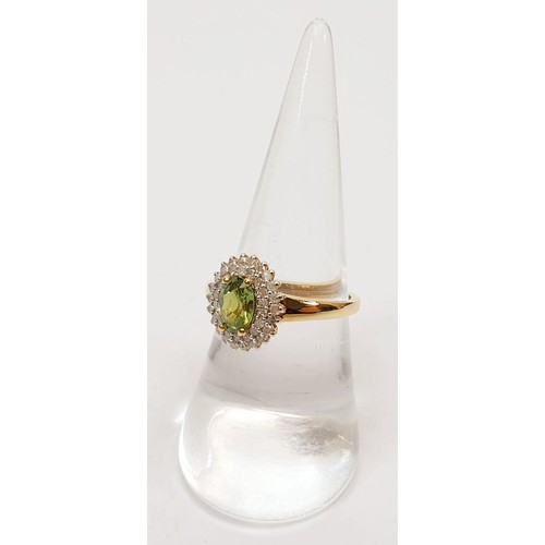 69 - A hallmarked 18ct gold peridot and diamond cluster ring, size O, gross weight 3.4g. UK shipping £14.