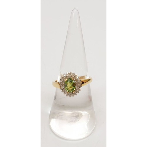 69 - A hallmarked 18ct gold peridot and diamond cluster ring, size O, gross weight 3.4g. UK shipping £14.