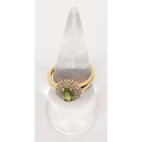 69 - A hallmarked 18ct gold peridot and diamond cluster ring, size O, gross weight 3.4g. UK shipping £14.