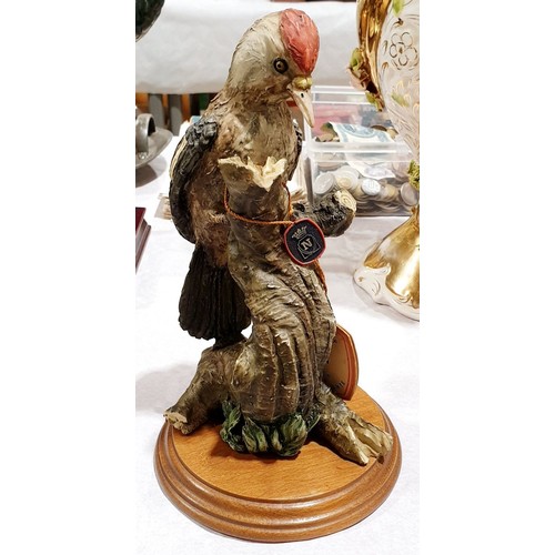 135 - A resin Capodimonte figure of a woodpecker, height 9.5