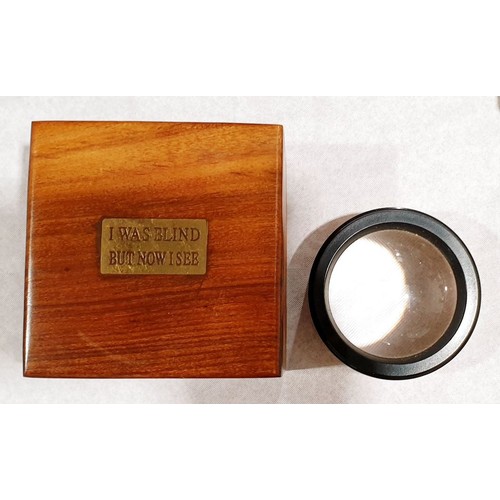 140 - A wooden box with a magnifier, with a brass plaque inscribed 