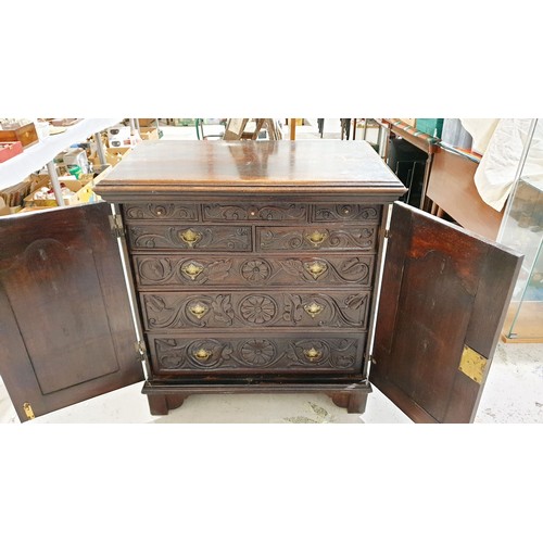 243 - An 18th century oak eight drawer chest of drawers with later carving, width 39