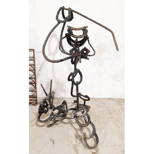 279 - A wrought iron sculpture of a golfer, height 43