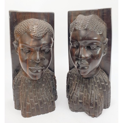 302 - A pair of Lignum vitae bookends carved as an African man and woman, height 9.5