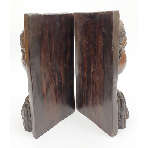 302 - A pair of Lignum vitae bookends carved as an African man and woman, height 9.5