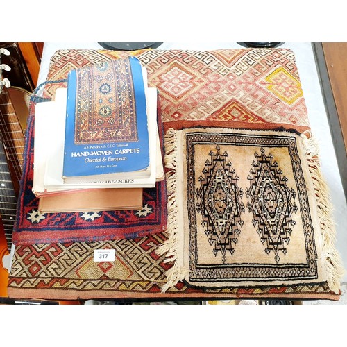 317 - An eastern wool cushion, bag and small mat together with books on hand woven carpets. No shipping. A... 