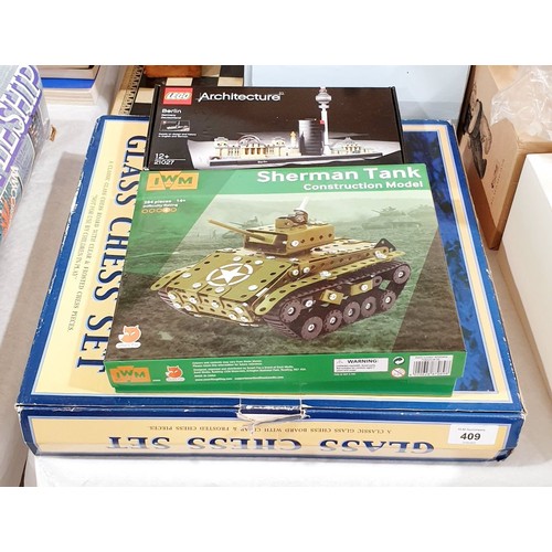 409 - A sealed Lego Architecture Berlin Kit together with a Sherman Tank construction model and a glass ch... 