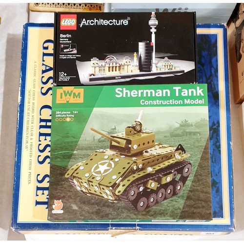 409 - A sealed Lego Architecture Berlin Kit together with a Sherman Tank construction model and a glass ch... 