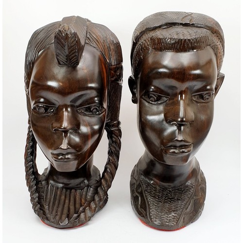 299 - A pair of carved lignum vitae busts of an African boy and girl, height 11.75