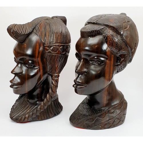 299 - A pair of carved lignum vitae busts of an African boy and girl, height 11.75