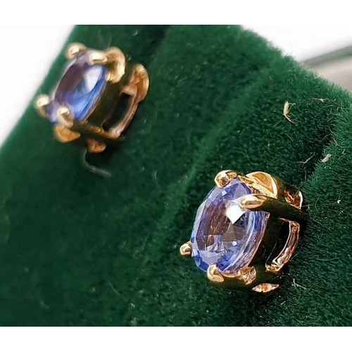 9 - A pair of 9ct gold earrings set with sapphires, gross weight 0.9g. UK shipping £14.