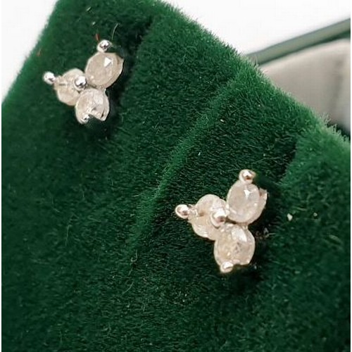 12 - A pair of hallmarked 9ct white gold earrings set with diamonds, weight 0.8g. UK shipping £14.