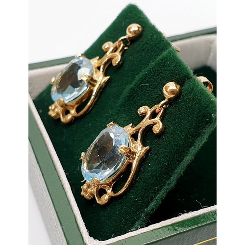 14 - A pair of hallmarked 9ct gold drop earrings set with topaz, gross weight 2.7g. UK shipping £14.