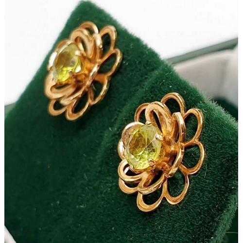 15 - A pair of hallmarked 9ct gold earrings set with peridot, gross weight 1.4g. UK shipping £14.