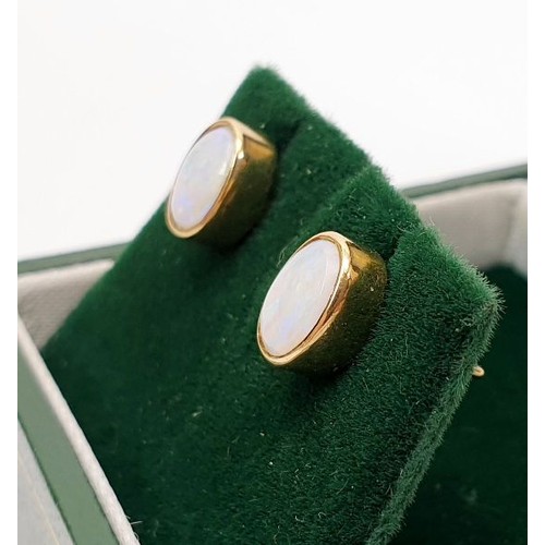 18 - A pair of 9ct gold earrings set with opal, gross weight 1.6g. UK shipping £14.