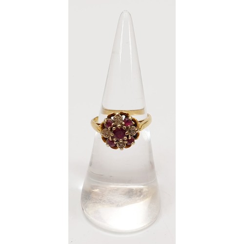 21 - A 9ct gold diamond and ruby cluster ring, size K, gross weight 4.1g. UK shipping £14.