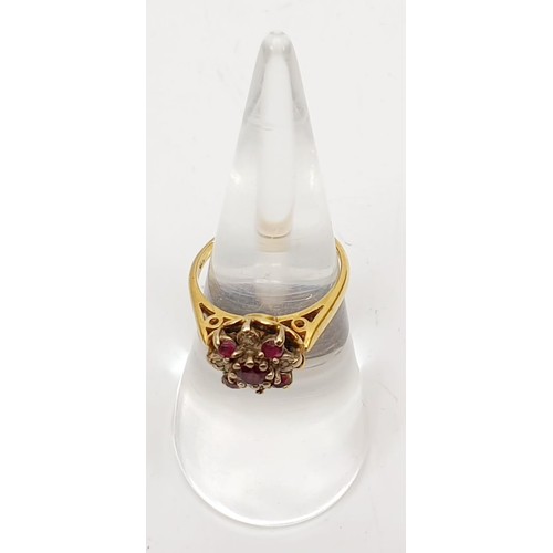 21 - A 9ct gold diamond and ruby cluster ring, size K, gross weight 4.1g. UK shipping £14.