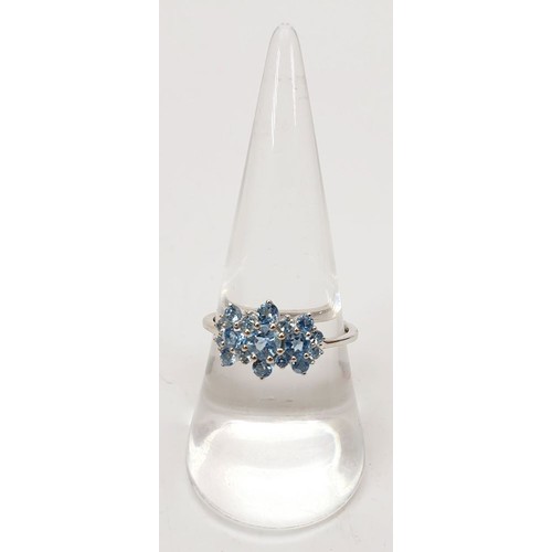 24 - A hallmarked 9ct white gold ring set with aquamarines, size P/Q, gross weight 2g. UK shipping £14.