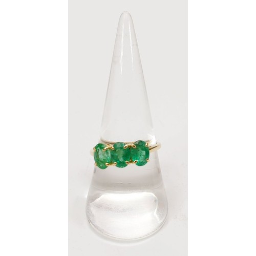 27 - A hallmarked 9ct gold ring set with three emeralds, size Q, gross weight 2.1g. UK shipping £14.