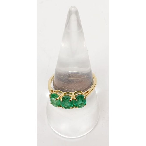 27 - A hallmarked 9ct gold ring set with three emeralds, size Q, gross weight 2.1g. UK shipping £14.