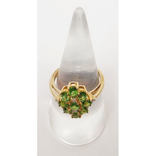 48 - A hallmarked 9ct gold tsavorite and diamond cluster ring, size N/O, gross weight 4.2g. UK shipping £... 