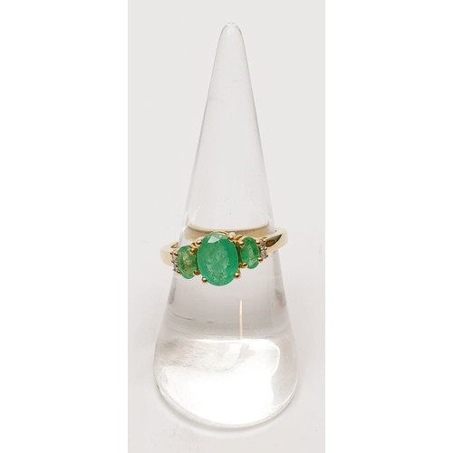 54 - A hallmarked 9ct gold three stone emerald ring, size O, gross weight 2.8g. UK shipping £14.