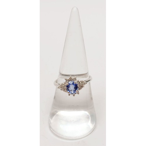 57 - A hallmarked 14ct white gold sapphire and diamond cluster ring, size N/O, gross weight 2.6g.